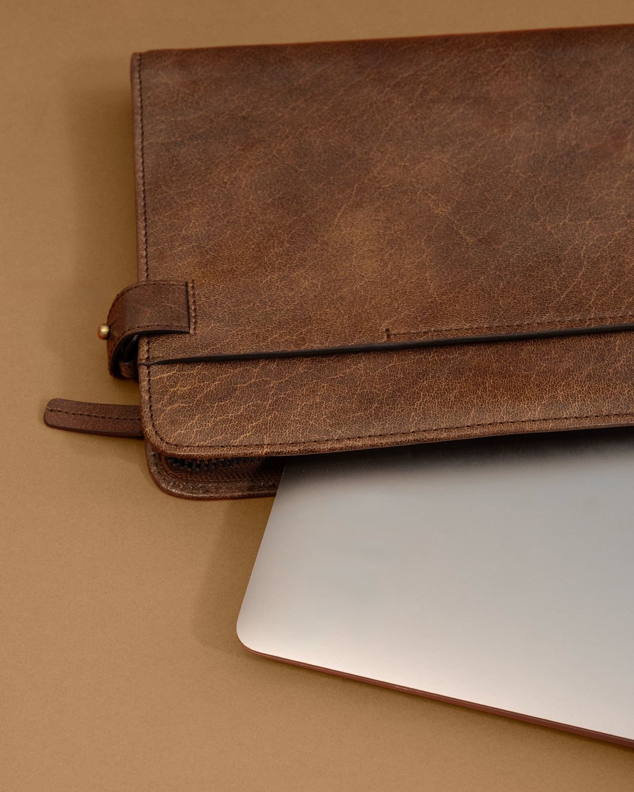 Brown leather tech accessory and laptop sleeve