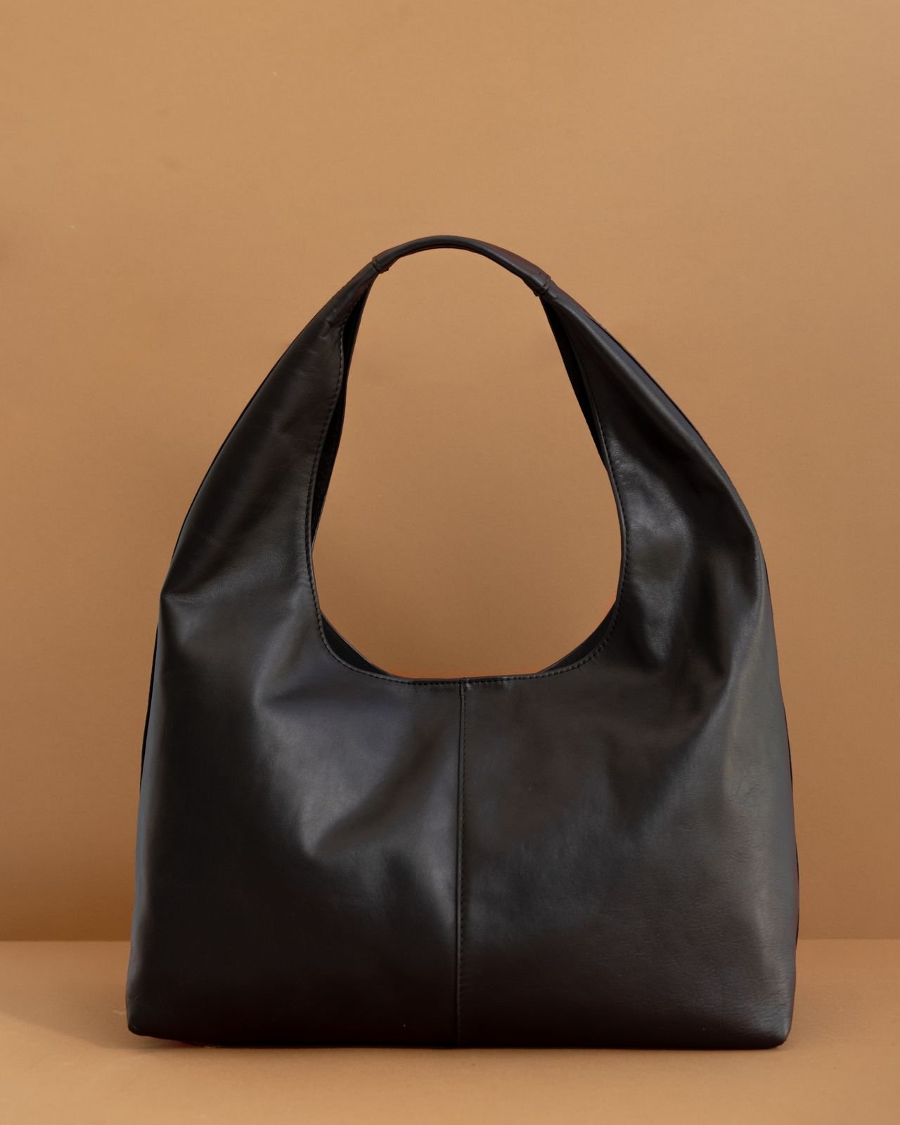 Structured black leather handbag on display